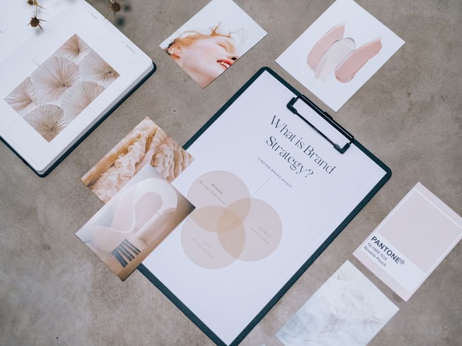 Brand strategy sheets and printed sample cards on a desk