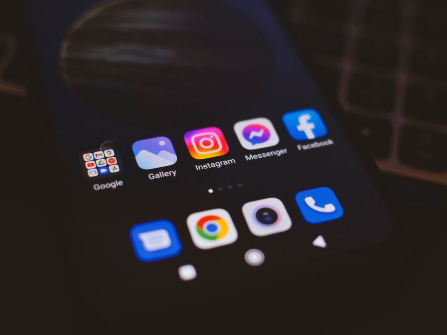 Mobile phone showing social media applications on screen