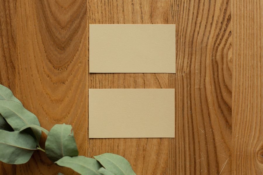 Blank business cards arranged on a wooden table