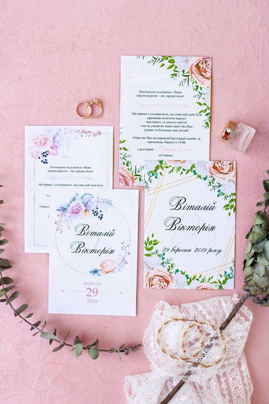 Floral wedding invitation suite laid out flat